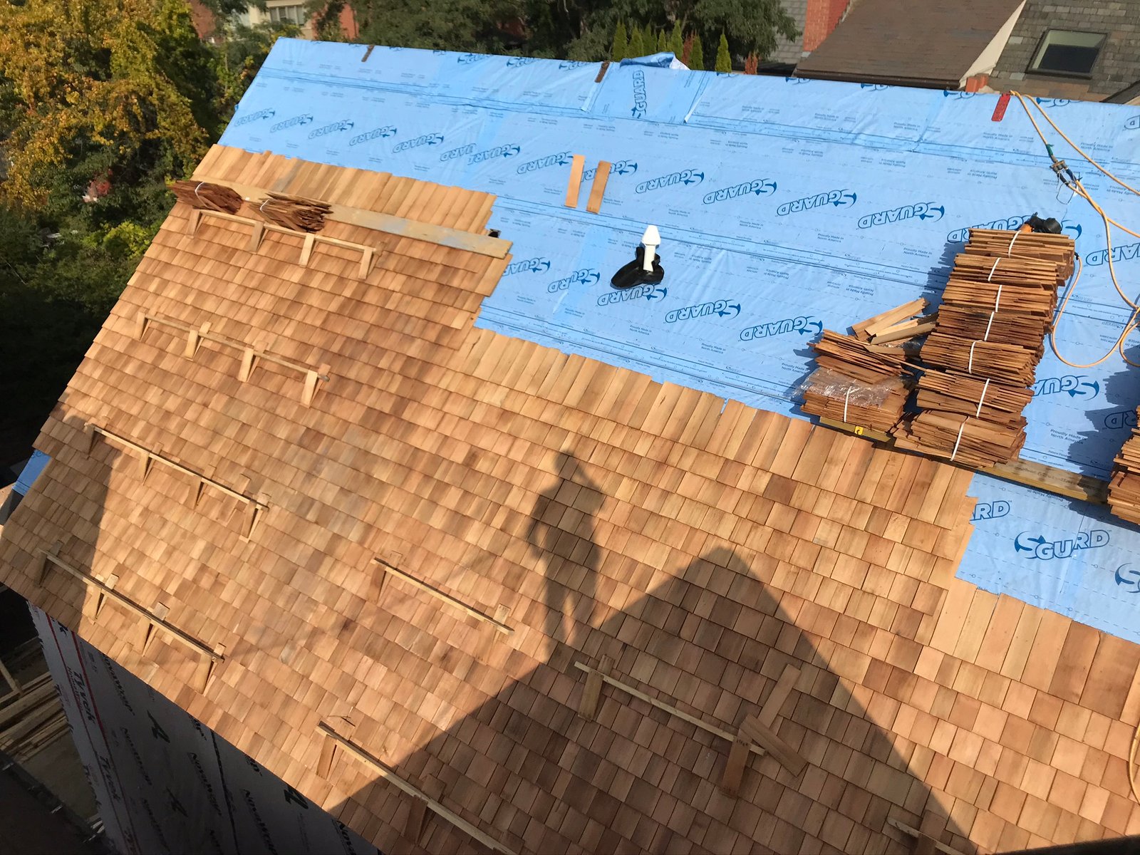 Cedar shake roof installation in progress